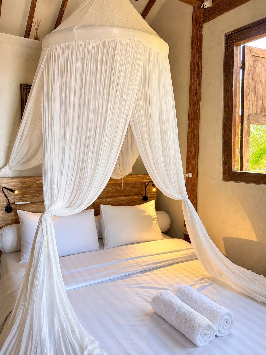 Bedroom with canopy bed and warm light